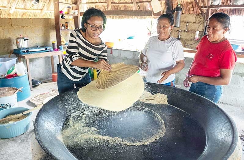 At Morai Rupununi Ranch in Katoonarib, Region Nine, a traditional experiential experience is being offered. Tourists can participate in bow and arrow making, cassava bread making and other activities. Photographed is Minister of Tourism, Industry and Commerce, Oneidge Walrond, learning the art of making cassava bread (Delano Williams photo)