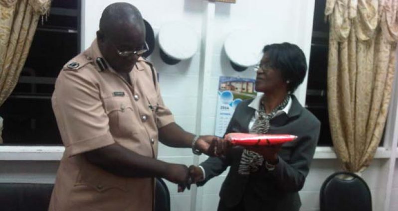 Commander Griffith receives the donation from attorney-at-law, Gwendolyn Bristol on behalf of the Sparendaam Station Management committee