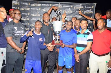 Director of Sport Director Chris Jones hands over the winners’ trophy to a jubilant  Sparta Boss team .