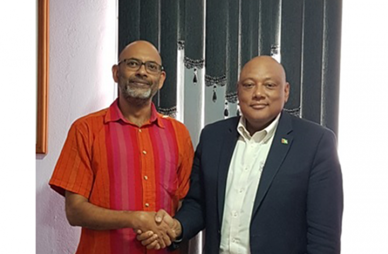 Rahul Basu exchanges a handshake with Minister of Natural Resources, Raphael Trotman