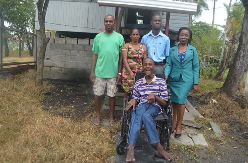 Young Wills flanked by his parents and officials of the Region Four Administration