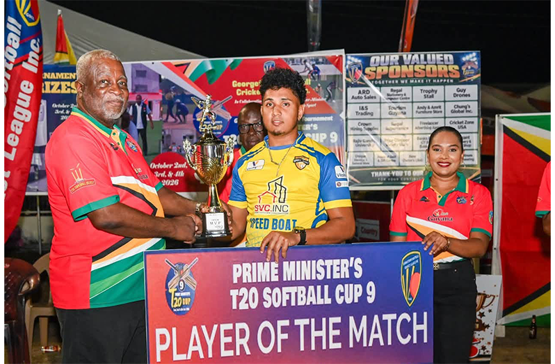 Player of the match Ameer Mohamed receives his award from Prime Minister Brigadier (Ret’d) Mark Phillips in the presence of GSCL Secretary, Telesha Ousman