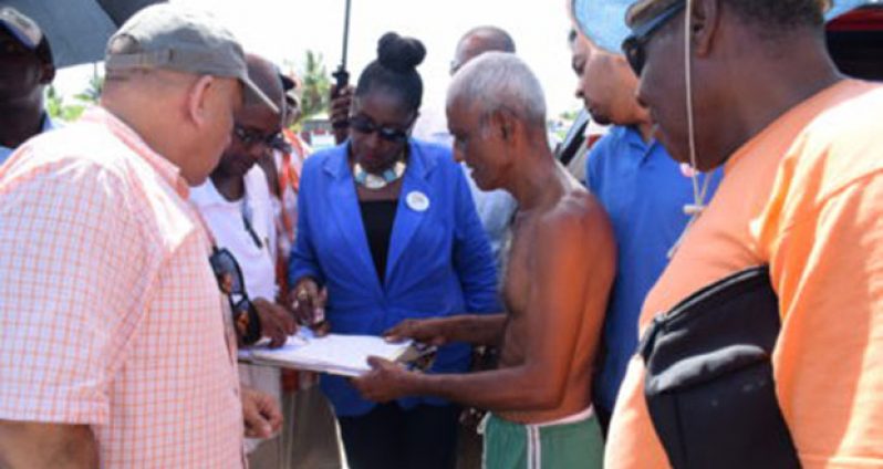 Minister within the Ministry of Communities, Valerie Adams-Patterson, listens to the concerns of a resident at Tuschen