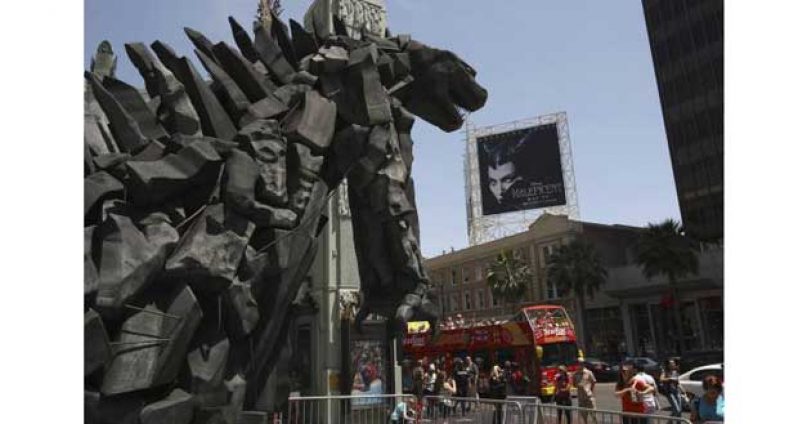 A tourist bus passes a statue of movie monster Godzilla in front of the TCL Chinese Theatre IMAX forecourt on Hollywood Boulevard in the Hollywood section of Los Angeles, California, May 9, 2014.
Credit: Reuters/David McNew