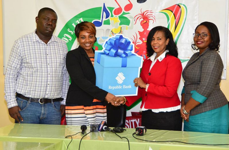 Permanent Secretary of the Ministry of Social Cohesion with responsibility for Culture, Youth and Sport, Ms Melissa Tucker, (second from left) receiving a $2.8M cheque from the Manager of Republic Bank, Water Street branch, Ms Celine Davis, for sponsorship of the ministry's Pan-O-Rama activities. In photograph are also Mashramani Coordinator Mr Andrew Tyndall and Communications and Public Relations officer of the Bank, Ms Jonelle Dummett. The handing over of the cheque was done on Wednesday in the ministry's boardroom.