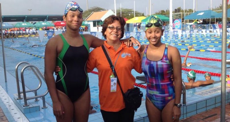 Britany van Lange (left) and Soroya Simmons (right) pose with coach Stephanie Fraser while in Aruba.