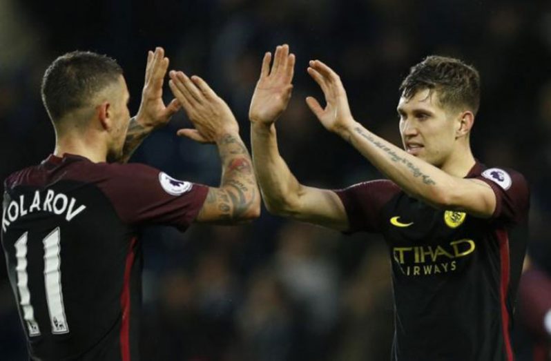 Manchester City's Aleksandar Kolarov and John Stones celebrate after the match Action Images via Reuters / Andrew Boyers.