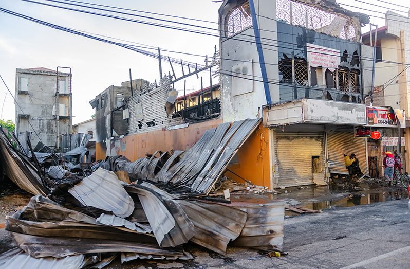 What is left of Singh’s Electronic World following a fire which ignited at the old Sachi’s Building where a tent was constructed (Delano Williams Photo)