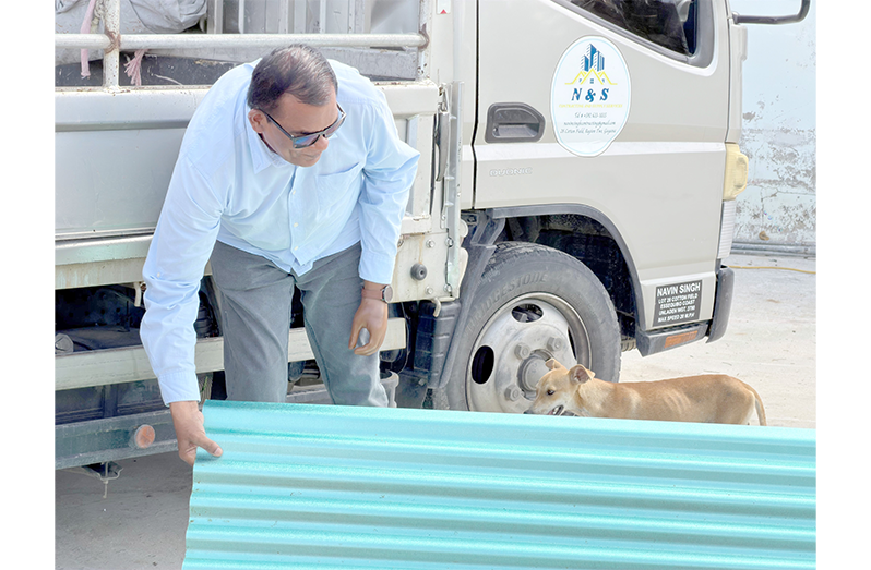 Minister within the Ministry of Public Works Madanlall Ramraj assisting workers