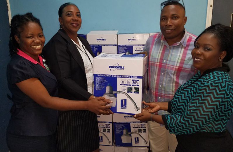 Linden Deputy Mayor, Ms Waneka Arrindell (right) hands over a few lamps to  constituency representatives