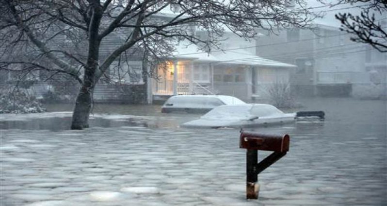 Water floods a street on the coast in Scituate, Massachusetts