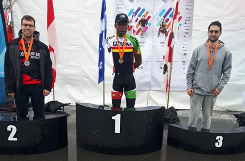 Guyana’s Walter Grant-Stuart (centre) standing on the winner’s podium after being declared the winner of the road race.