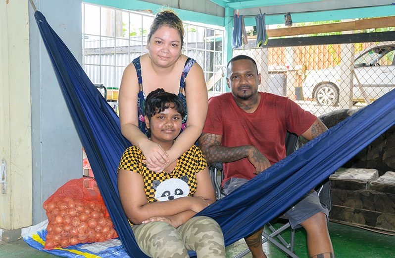 Tajhol Rambarran, her mother Sattie and father Yubraj at their Grove Housing Scheme home (Delano Williams photo)