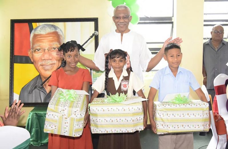 President David Granger with the NGSA top students honoured on his birthday (Ministry of the Presidency photo) 
 