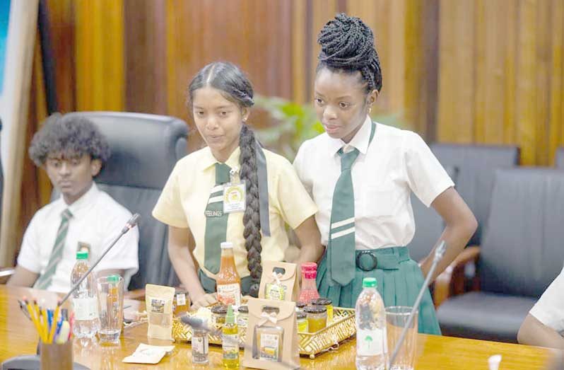 President Dr Irfaan Ali interacts with students participating in the agro-processing summer camp, as they showcase value-added products made from locally grown produce