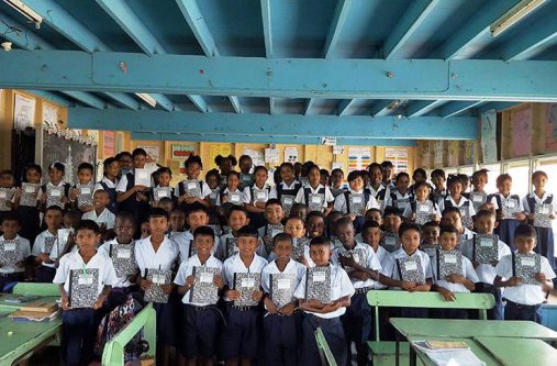 Children of both sections of the Enterprise school show off what they received