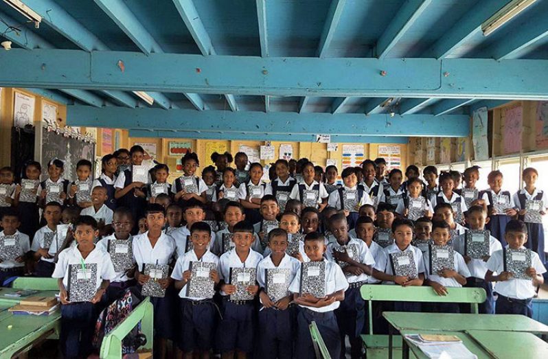 Children of both sections of the Enterprise school show off what they received