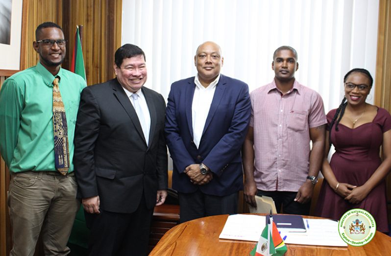 Minister Raphael Trotman and Ambassador Ivan Roberto Sierra with the scholarship awardees