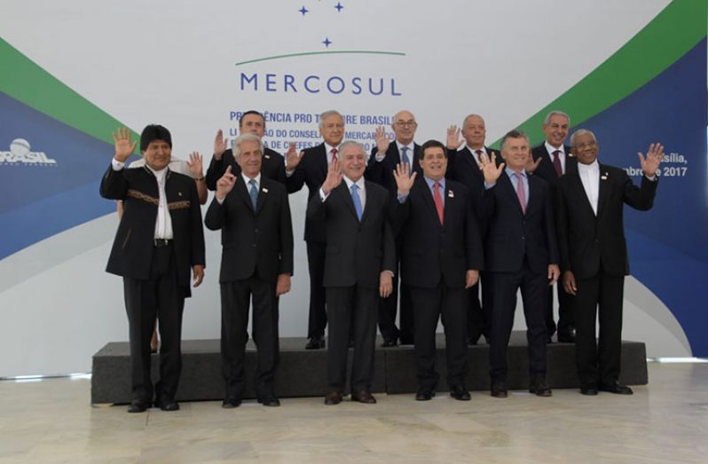 President David Granger (extreme right,front row) poses with other leaders of MERCOSUR during their summit in Brazil on Thursday (Ministry of the Presidency photo)