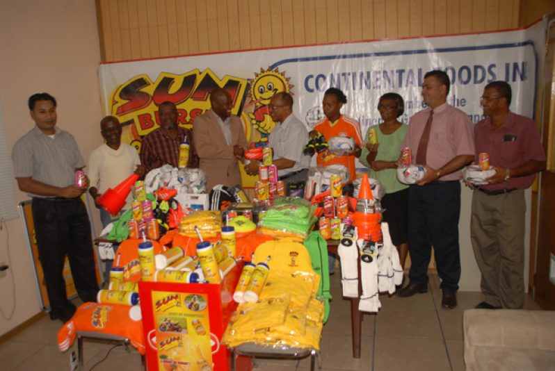 In this Sonell Nelson photo, Camptown FC president James Bond (fourth left) accepts part of the gear and equipment from Continental‘s Company Secretary Percival Boyce. Others in photo are from left, Continental’s Anesh Persaud, club coach Joseph Wilson, secretary Ackram Sabree, club captain Travis Martin, Continental’s Sharon Blackman, Ravi Brijmamdan and Rajendra Madhu.