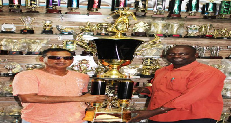 Trophy Stall owner Ramesh Sunich (left) making his presentation to K&S official Aubrey ‘Shanghai’ Major.