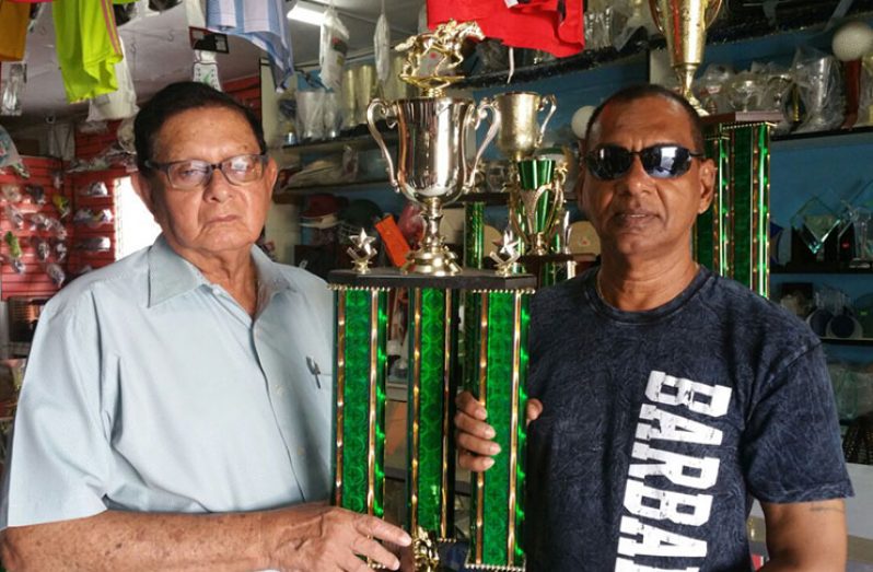 Trophy Stall Managing Director Ramesh Sunich (right) is seen presenting the Best Jockey trophy to Justice Cecil Kennard.