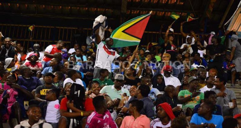 A Guyanese supporter proudly waves the Golden Arrowhead in the stands on Sunday night.

(Photos courtesy Barbados Football Association)