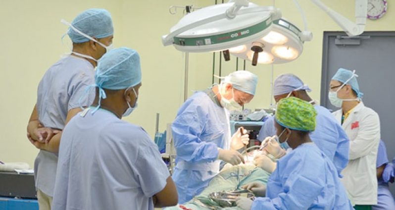 The Chinese Medical Team performing a spinal surgery on a patient at the New Amsterdam Hospital