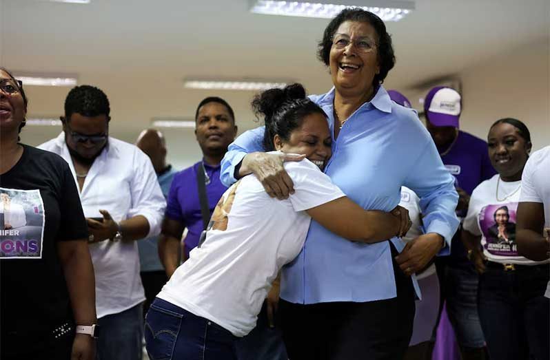 Suriname's opposition leader Jennifer Geerlings-Simons of the National Democratic Party (NDP) celebrates with supporters as she proclaims herself the winner of the presidency as counting