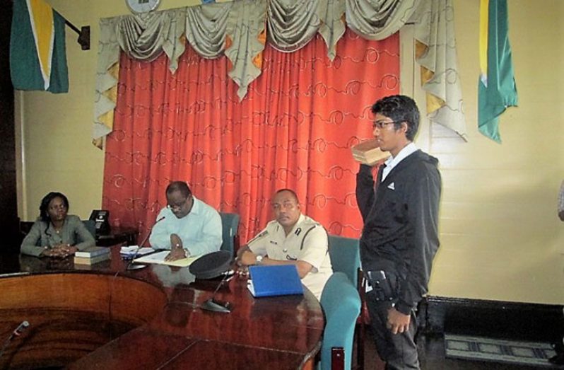 One of the parking meter attendants being sworn in in the presence of Town Clerk, Royston King, (centre), Chief Constable, Andrew Foo and Deputy Town Clerk, Sharon Harry-Munroe
