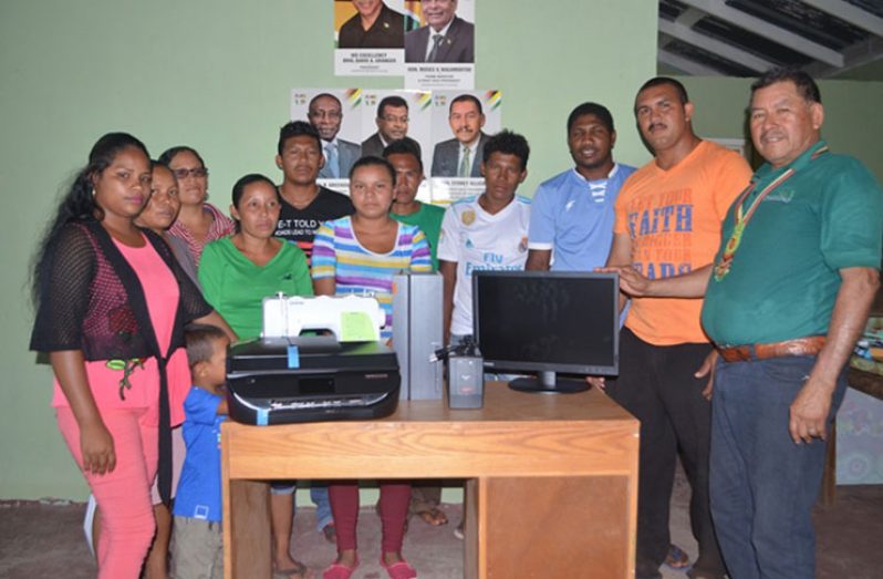 Minister of Indigenous Peoples’ Affairs, Sydney Allicock handing over the equipment to youths of Aranaputa in the presence of Chairman of the Community, Adon Jacabus