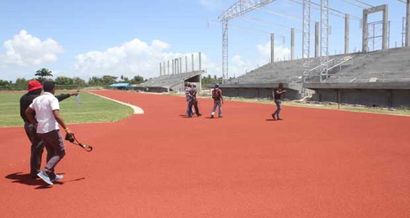 In his Sonell Nelson photo, Deputy Permanent Secretary Steve Ninvalle is seen pointing to a part of the  synthetic track.