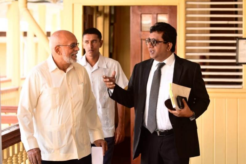 Former President Donald Ramotar chats with his lawyer , MP Anil Nandlall as they made their way to court on Thursday. (Samuel Maughn photo)