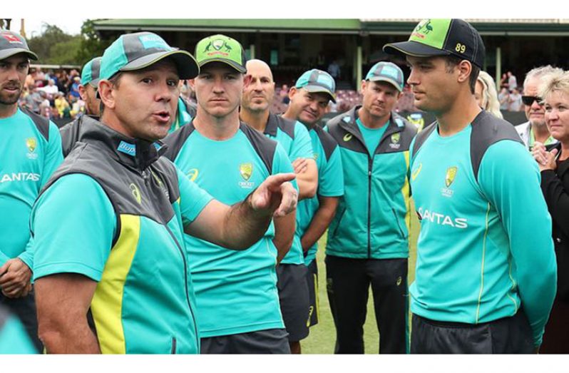 Ricky Ponting presents Alex Carey and D'Arcy Short with their Australian T20 caps in 2018. (Getty)