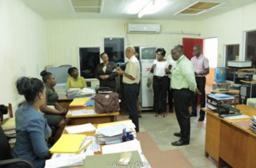 Public Health Minister, Volda Lawrence, listens attentively to a staff member during her visit