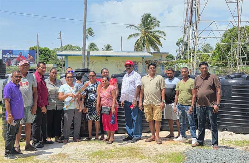 Minister within the Ministry of Local Government and Regional Development, Anand Persaud and Director General, Madanlall Ramraj, with farmers who benefitted