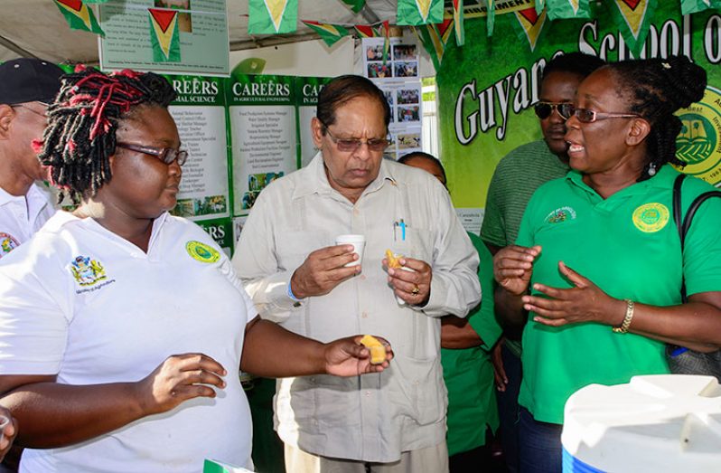 Prime Minister Nagamootoo samples foods on display at the exhibition