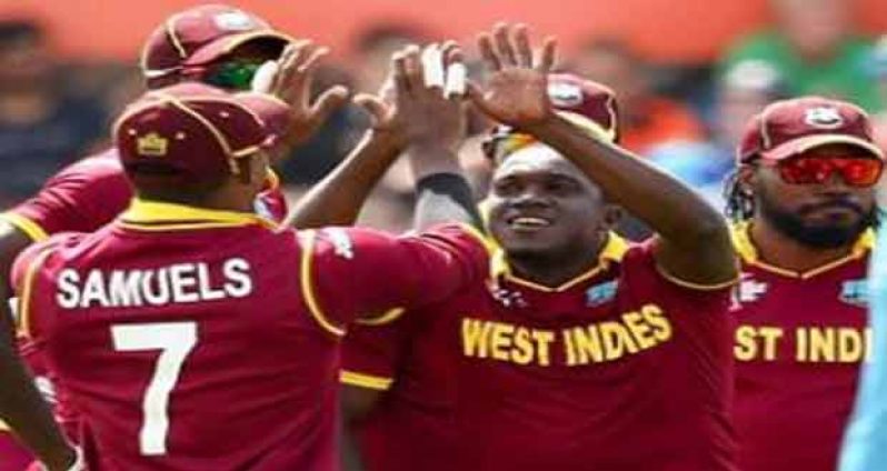 Fast bowler Jerome Taylor (second from right) celebrates with teammates at the fall of another wicket