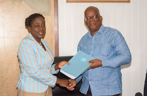 Minister of Finance, Winston Jordan hands over the US$13.3M loan agreement to Minister of Education, Nicolette Henry
