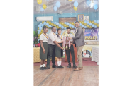 The elated students collect their trophy after winning the Ministry of Agriculture Hydromet Office’s 60th Anniversary Debating Competition