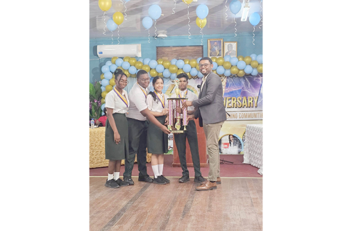 The elated students collect their trophy after winning the Ministry of Agriculture Hydromet Office’s 60th Anniversary Debating Competition