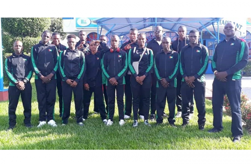 The 13 boxers and two coaches (opposite ends) will represent Guyana in T&T at the Caribbean Championships.