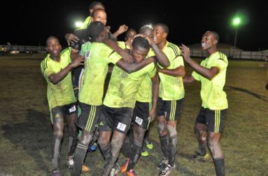 Hat-trick Boy! Grove Hi Tech leading marksman Domini Garnett (#11)  mobbed by teammates after he scores the winning goal against NA United at the Buxton ground.