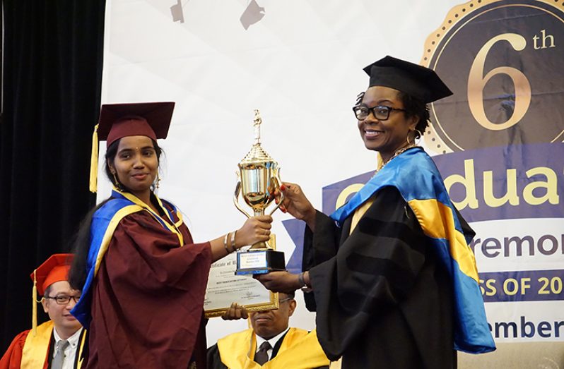 Texila American University Best Graduating Student of the December 2019 batch, Priya Jaganathan is presented on of her trophies by Deputy Chief Medical Officer, Dr. Karen Boyle (Elvin Croker photo)