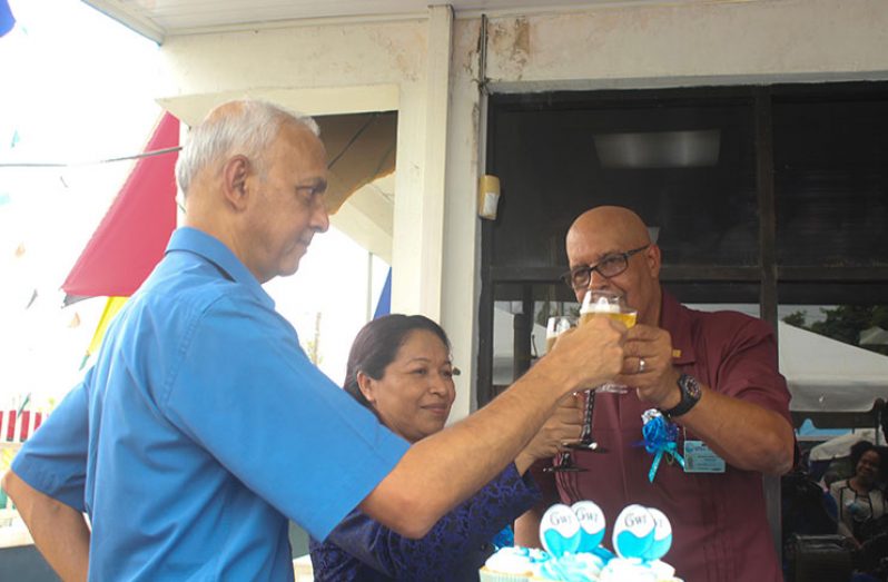 Minister of Communities Ronald Bulkan; Minister within the Ministry of Communities, Dawn Hastings-Williams and GWI Managing-Director Dr Richard Van-West Charles share a toast on the 15th anniversary