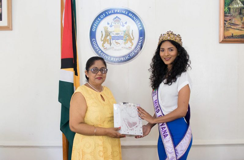 Mrs. Sita Nagamootoo presents Miss World Guyana 2018 with a token of appreciation (DPI photo)