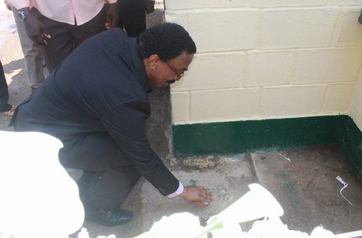 Minister of Legal Affairs and Attorney General, Basil Williams, bursts a coconut to symbolically reopen the Kara Kara Toll Booth