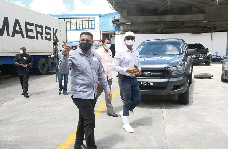 Minister of Agriculture Zulfikar Mustapha being taken on a tour of the Pritipaul Singh Investments Shrimp and Tuna Processing Plant at cDoom on Tuesday by its owner, Mr. Pritipaul Singh