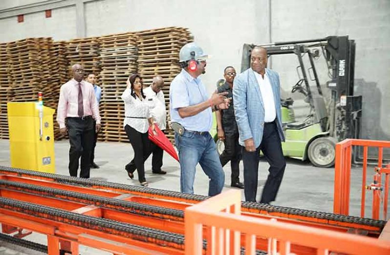 Minister of State Joseph Harmon during a tour of KSM Investments Limited