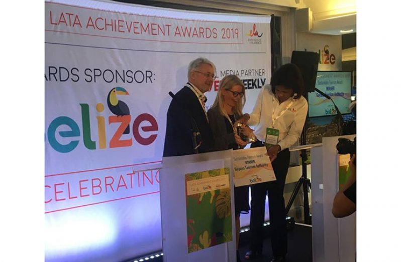 UK Market Rep, Kate McWilliams of Lotus UK, receiving the award on Guyana's behalf